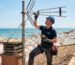 Técnico profesional revisando la instalación de antena de televisión en un tejado de Cádiz.
